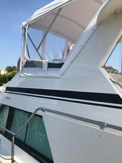  Yacht Photos Pics 1994 Hatteras 42 Cockpit Motor Yacht with sleek design and clear enclosure.