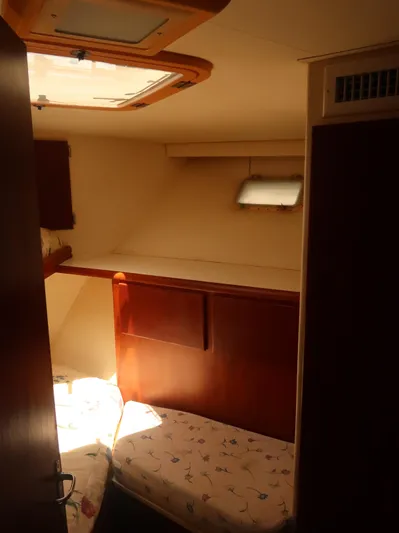  Yacht Photos Pics Cozy cabin interior of 1994 Hatteras 42 Cockpit Motor Yacht with twin beds and wooden accents.