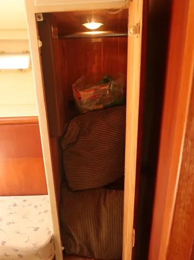  Yacht Photos Pics 1994 Hatteras 42 Cockpit Motor Yacht interior closet with cushions and storage items.
