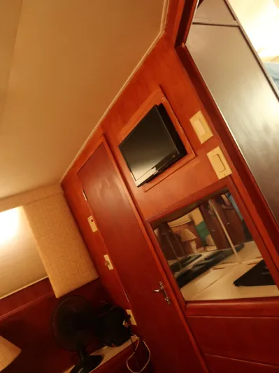  Yacht Photos Pics 1994 Hatteras 42 Cockpit Motor Yacht interior with wood paneling and mounted TV.