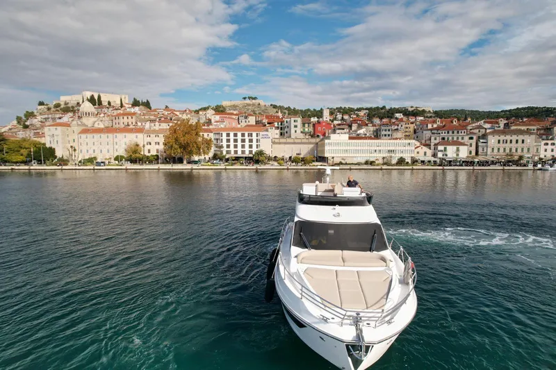  Yacht Photos Pics Azimut Fly 53 yacht cruising near a scenic coastal town, 2024 model.