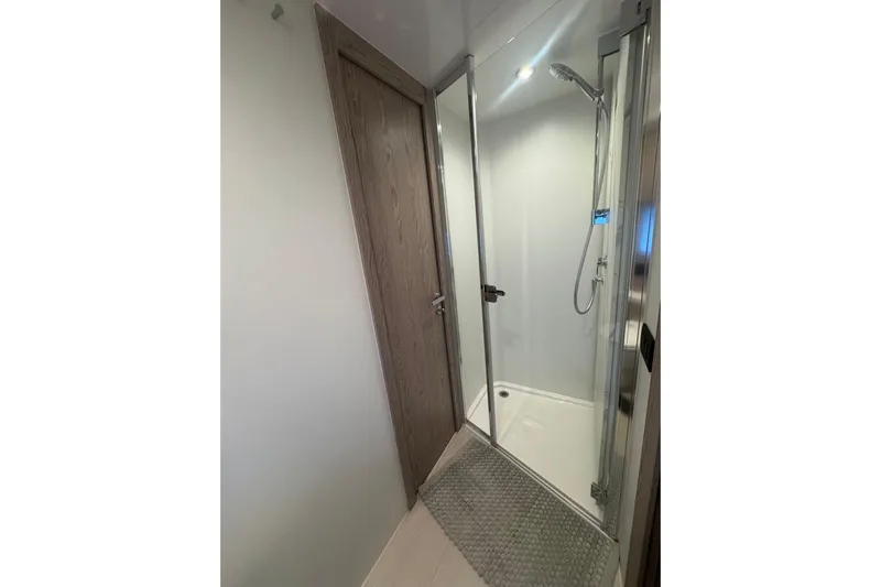  Yacht Photos Pics 2024 Azimut Fly 53 yacht bathroom with modern shower and wooden door.