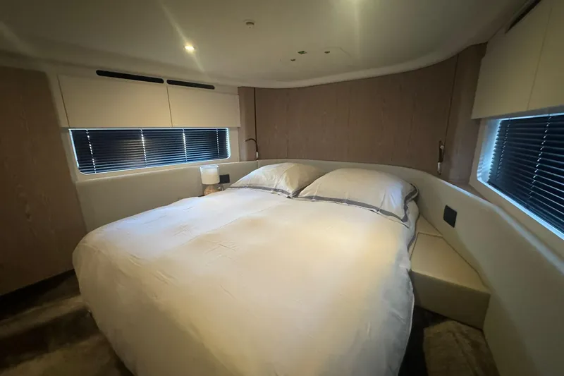  Yacht Photos Pics Luxurious bedroom interior of 2024 Azimut Fly 53 yacht with modern design and cozy bedding.