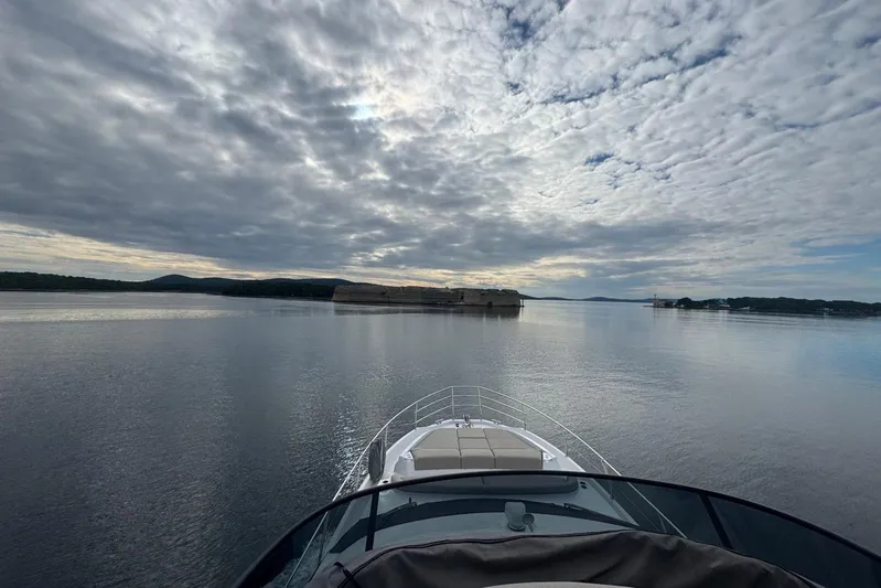 Yacht Photos Pics Azimut Fly 53 yacht cruising on calm waters under a cloudy sky, 2024 model.