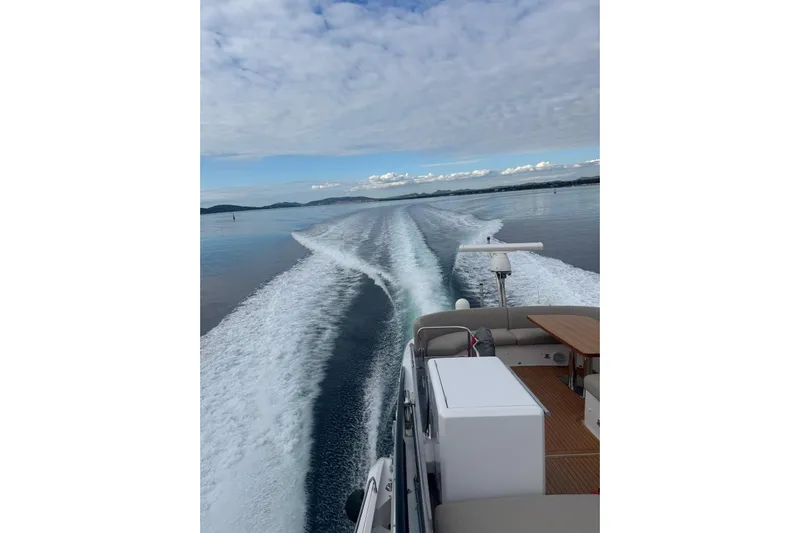  Yacht Photos Pics 2024 Azimut Fly 53 yacht cruising on calm waters, leaving a wake trail.