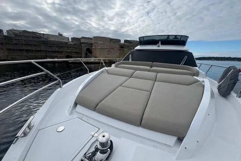  Yacht Photos Pics 2024 Azimut Fly 53 yacht with spacious sunbathing area, docked near historic stone structure.