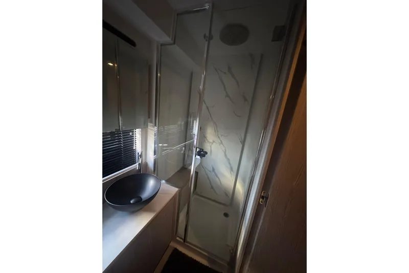  Yacht Photos Pics Luxurious bathroom in 2024 Azimut Fly 53 yacht with modern shower and sleek basin.