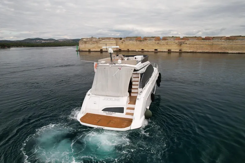  Yacht Photos Pics 2024 Azimut Fly 53 yacht cruising near historic stone fort.