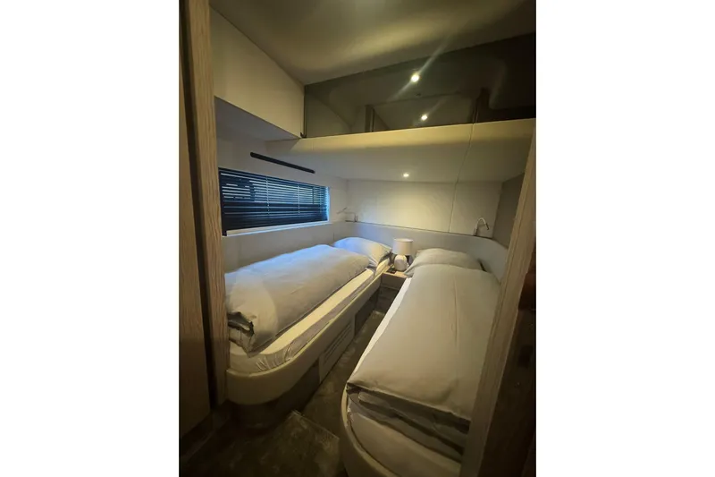  Yacht Photos Pics Luxurious twin bedroom in 2024 Azimut Fly 53 yacht, featuring modern design and ambient lighting.
