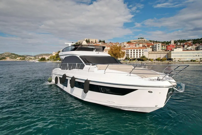  Yacht Photos Pics 2024 Azimut Fly 53 yacht on serene water with scenic coastal backdrop.