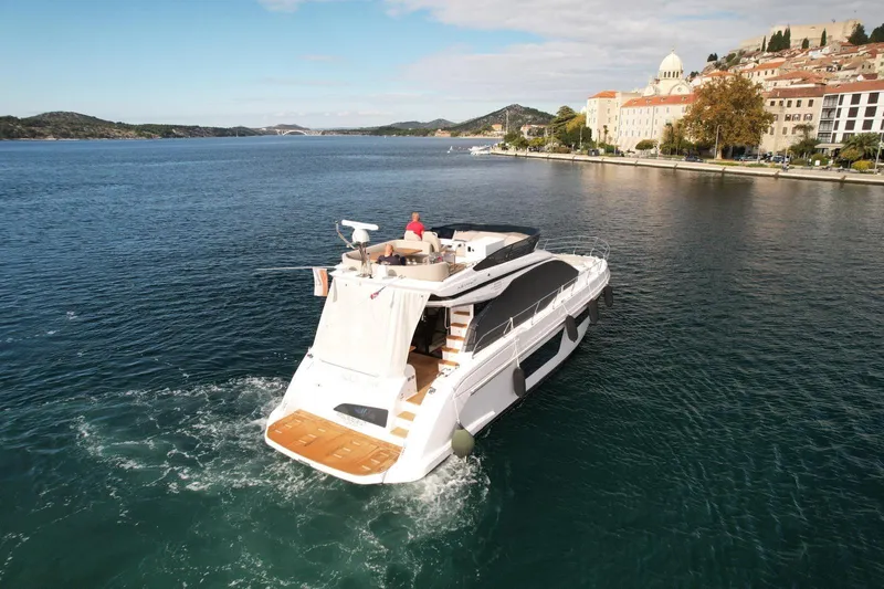  Yacht Photos Pics 2024 Azimut Fly 53 yacht cruising near scenic coastal town.