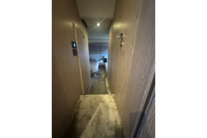  Yacht Photos Pics Narrow hallway inside 2024 Azimut Fly 53 yacht, leading to a cozy bedroom.