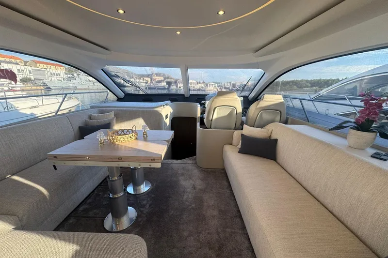  Yacht Photos Pics Luxurious interior of 2024 Azimut Fly 53 yacht with elegant seating and panoramic windows.