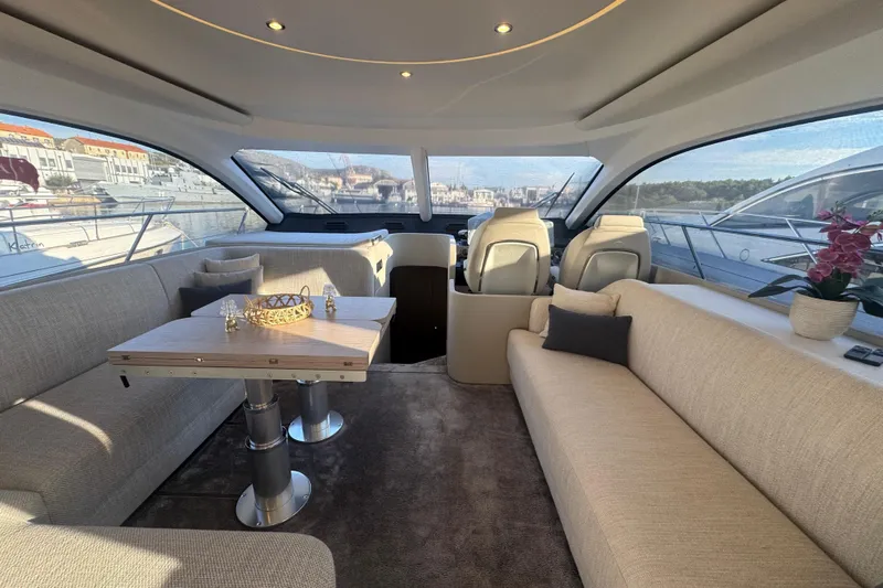  Yacht Photos Pics Luxurious interior of 2024 Azimut Fly 53 yacht with elegant seating and panoramic windows.