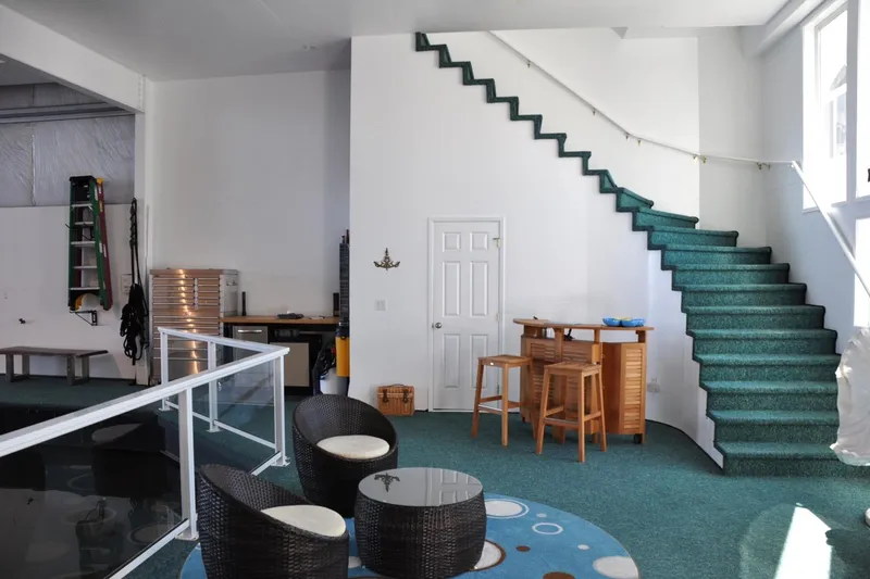  Yacht Photos Pics Interior of 2004 Steelhead Marine Boat House with modern furniture and green carpeted stairs.