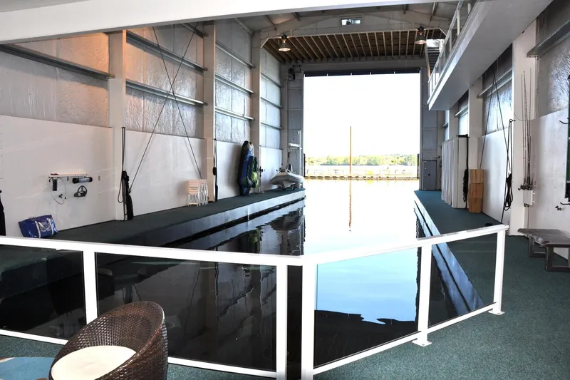  Yacht Photos Pics Indoor boat house with waterway, Steelhead Marine model, 2004, featuring modern design and seating area.