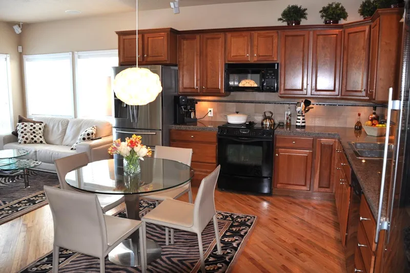  Yacht Photos Pics Modern kitchen with wooden cabinets, glass dining table, and cozy living area.