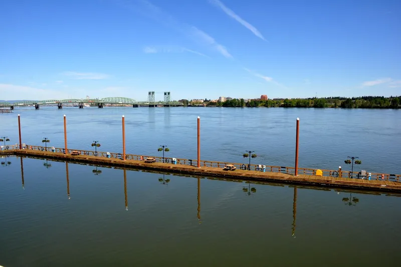  Yacht Photos Pics River view with a long dock, bridge, and clear blue sky. Steelhead Marine Boat House, 2004.