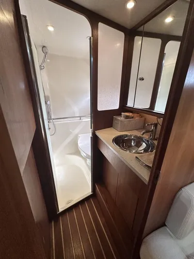 2008 Tiara 3500 Sovran Yacht Photos Pics 2008 Tiara Yachts 3500 Sovran bathroom with shower, sink, and wooden accents.