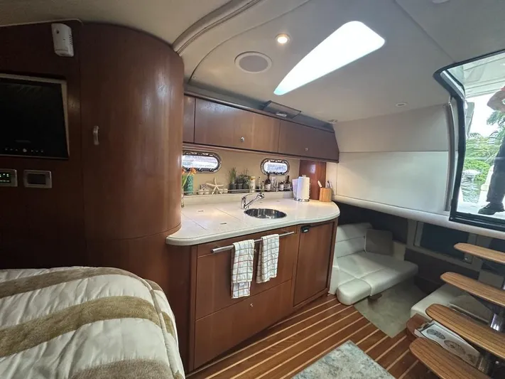 2008 Tiara 3500 Sovran Yacht Photos Pics 2008 Tiara Yachts 3500 Sovran interior with kitchenette, wooden cabinetry, and cozy seating area.