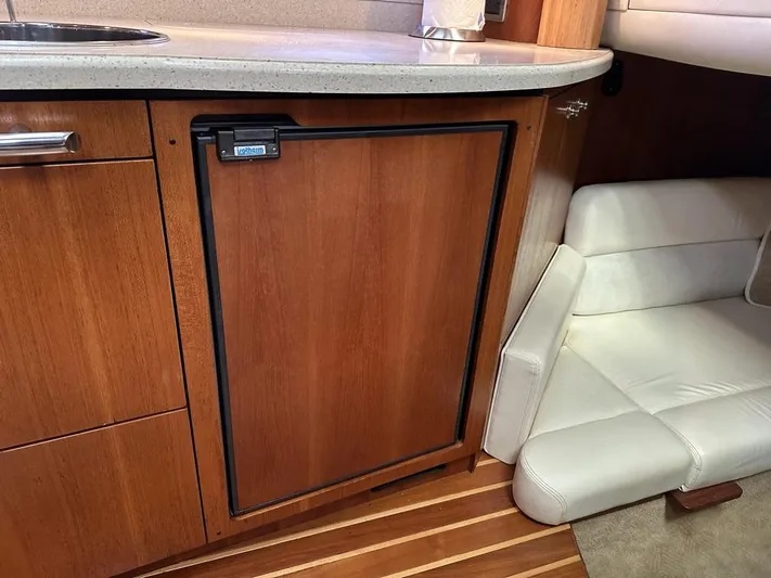 2008 Tiara 3500 Sovran Yacht Photos Pics 2008 Tiara Yachts 3500 Sovran interior with wooden cabinetry and compact seating area.