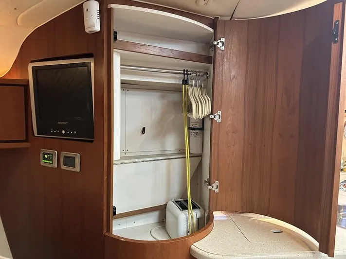 2008 Tiara 3500 Sovran Yacht Photos Pics 2008 Tiara Yachts 3500 Sovran interior with open wooden cabinet and TV.