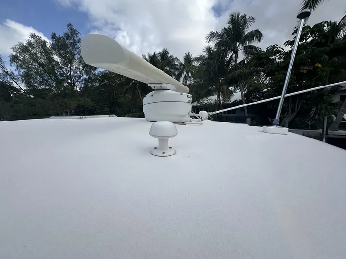 2008 Tiara 3500 Sovran Yacht Photos Pics 2008 Tiara Yachts 3500 Sovran deck with radar, surrounded by trees and cloudy sky.