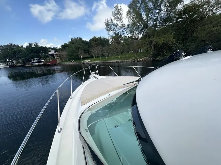 2008 Tiara 3500 Sovran Yacht Photos Pics 2008 Tiara Yachts 3500 Sovran on calm water, surrounded by trees and boats.