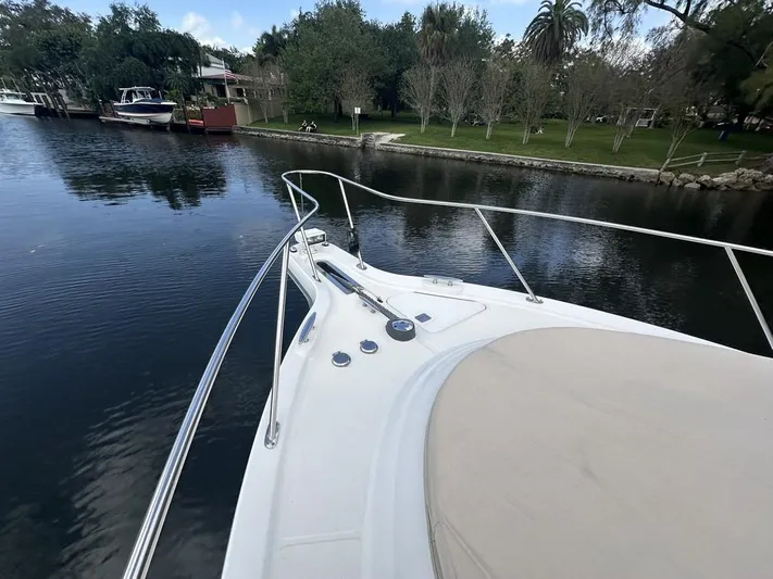 2008 Tiara 3500 Sovran Yacht Photos Pics 2008 Tiara Yachts 3500 Sovran on calm water near a lush shoreline.