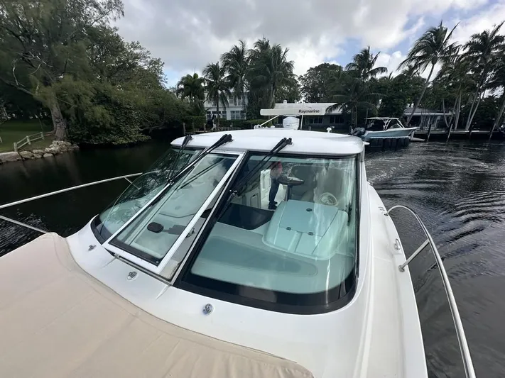 2008 Tiara 3500 Sovran Yacht Photos Pics 2008 Tiara Yachts 3500 Sovran cruising on a scenic waterway with lush greenery.