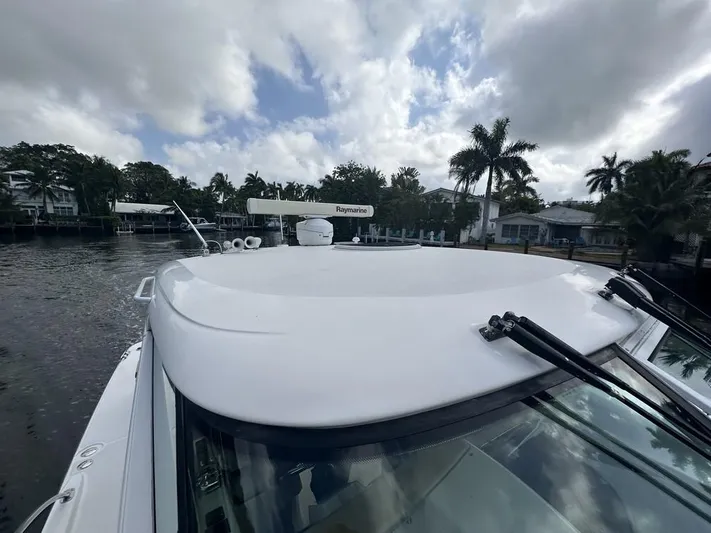 2008 Tiara 3500 Sovran Yacht Photos Pics 2008 Tiara Yachts 3500 Sovran on a calm waterway with palm trees in the background.