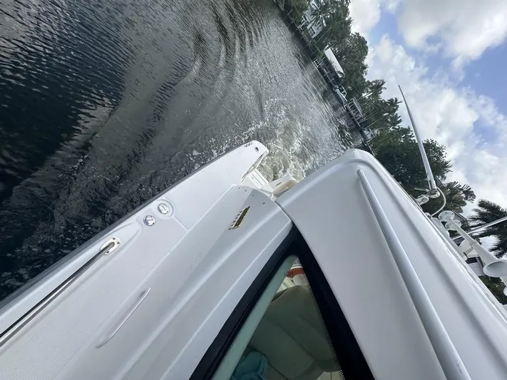 2008 Tiara 3500 Sovran Yacht Photos Pics 2008 Tiara Yachts 3500 Sovran cruising on a calm waterway under a partly cloudy sky.