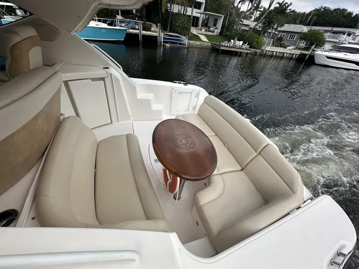 2008 Tiara 3500 Sovran Yacht Photos Pics 2008 Tiara Yachts 3500 Sovran with beige seating and wooden table on a calm waterway.