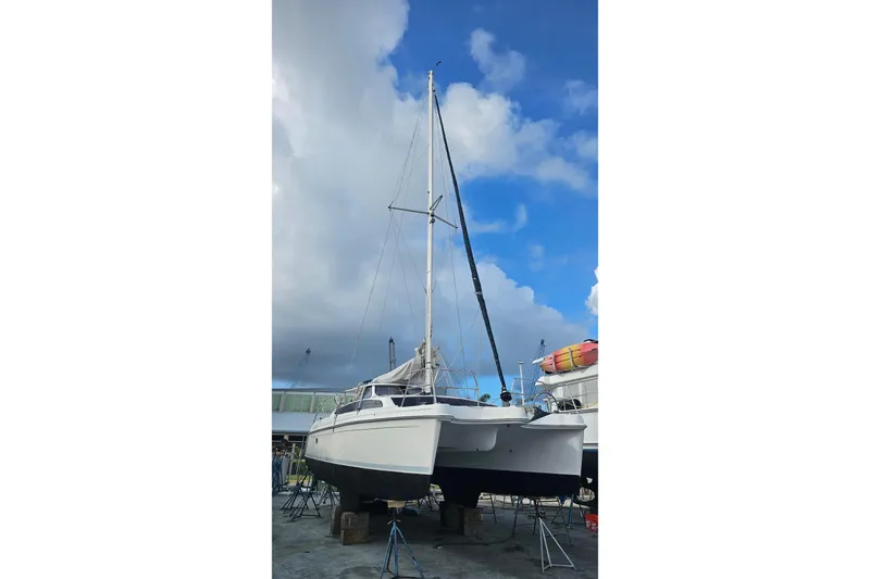 Rockstar Yacht Photos Pics 2013 Gemini Legacy catamaran on dry dock under a partly cloudy sky.