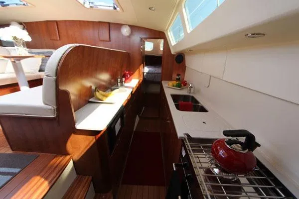 Rockstar Yacht Photos Pics Interior of 2013 Gemini Legacy yacht featuring kitchen and seating area with modern amenities.