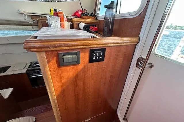 Rockstar Yacht Photos Pics Interior of 2013 Gemini Legacy boat with wooden cabinetry and kitchen area.