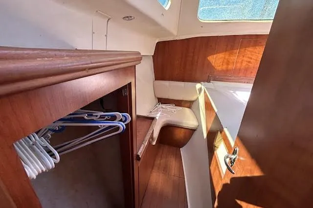 Rockstar Yacht Photos Pics Interior of 2013 Gemini Legacy boat with wooden cabinetry and seating area.