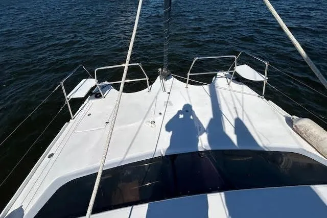 Rockstar Yacht Photos Pics 2013 Gemini Legacy boat deck with shadows on calm water.