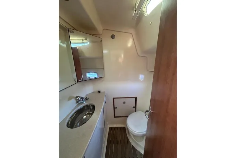 Rockstar Yacht Photos Pics 2013 Gemini Legacy boat bathroom with sink, mirror, and toilet.