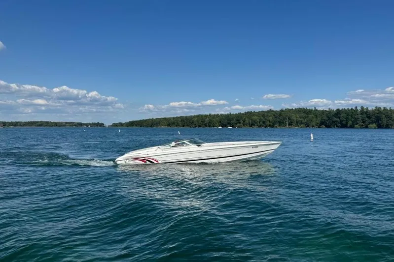  Yacht Photos Pics 2016 Formula 353 FASTech speedboat cruising on a clear blue lake under a sunny sky.