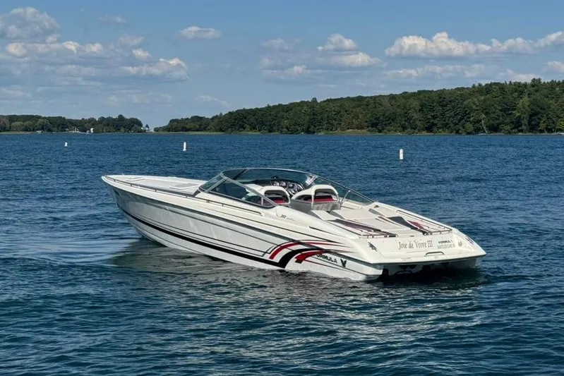  Yacht Photos Pics 2016 Formula 353 FASTech speedboat cruising on a serene lake under a clear sky.