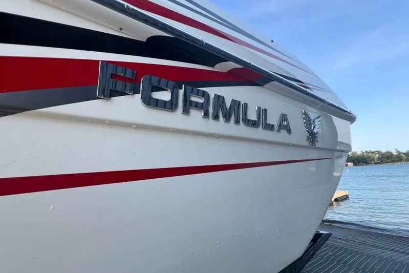  Yacht Photos Pics 2016 Formula 353 FASTech boat with sleek design and bold red accents by the water.