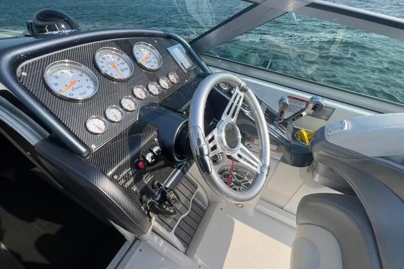  Yacht Photos Pics 2016 Formula 353 FASTech boat dashboard with gauges and steering wheel, overlooking water.