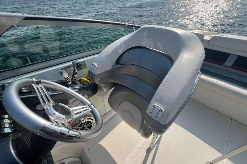  Yacht Photos Pics 2016 Formula 353 FASTech boat cockpit with steering wheel and seat, overlooking water.