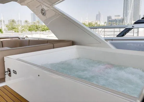  Yacht Photos Pics Luxurious 2018 Galeon 780 Crystal yacht with jacuzzi and seating area, docked in a city marina.