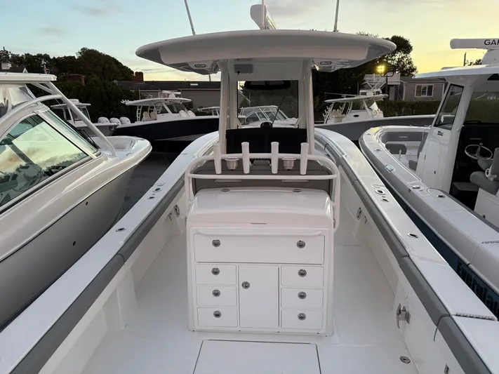 White Yacht Photos Pics 2024 Regulator 34 boat interior with storage compartments and seating, docked at sunset.