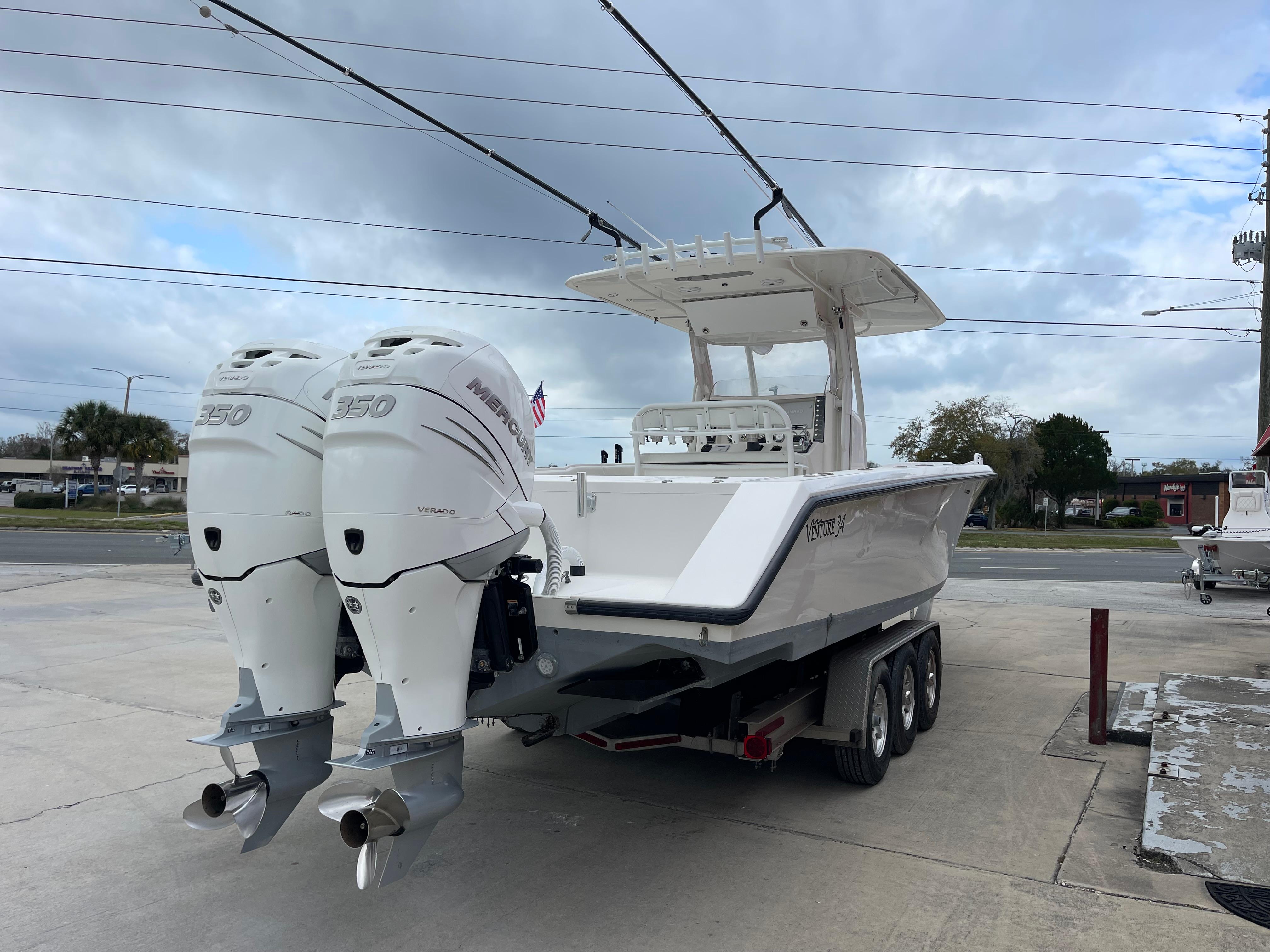 1999 Venture 34 Center Console boat with twin outboard engines on a trailer.