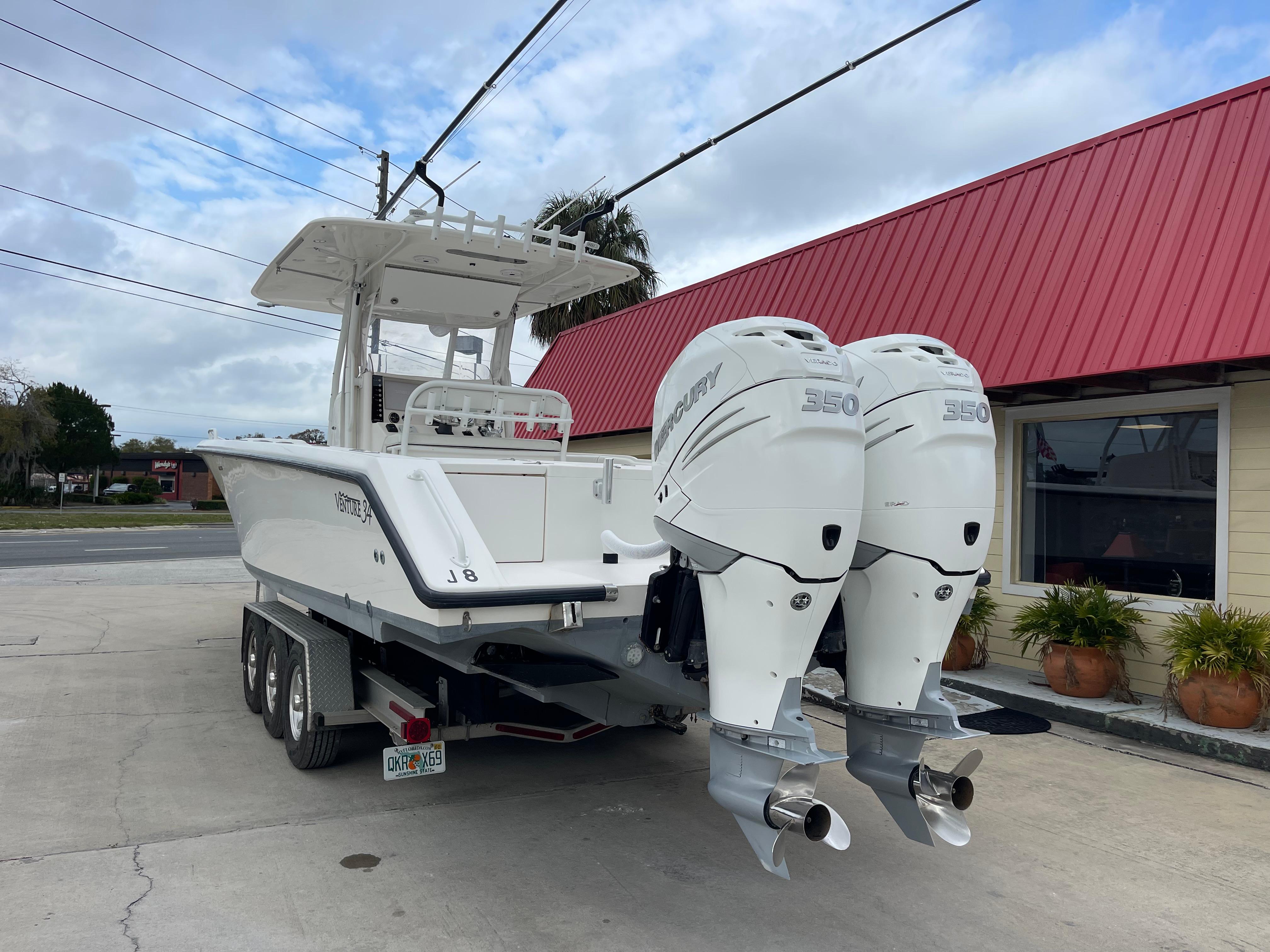 1999 Venture 34 Center Console boat with twin 350 horsepower engines on trailer.