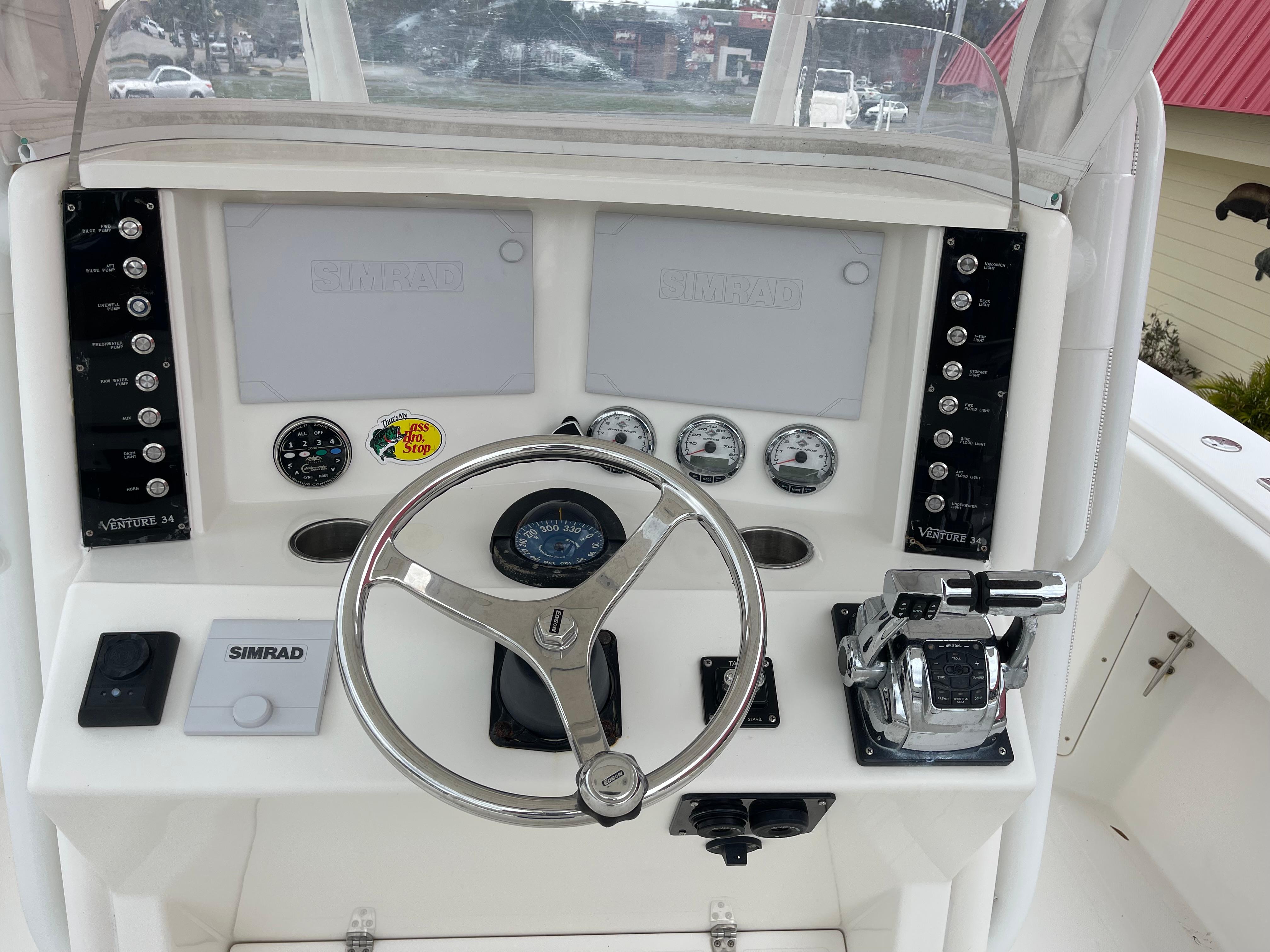 1999 Venture 34 Center Console boat helm with steering wheel and navigation instruments.