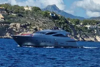 Luxury 2008 Pershing 90 yacht cruising near scenic coastal cliffs and villas.